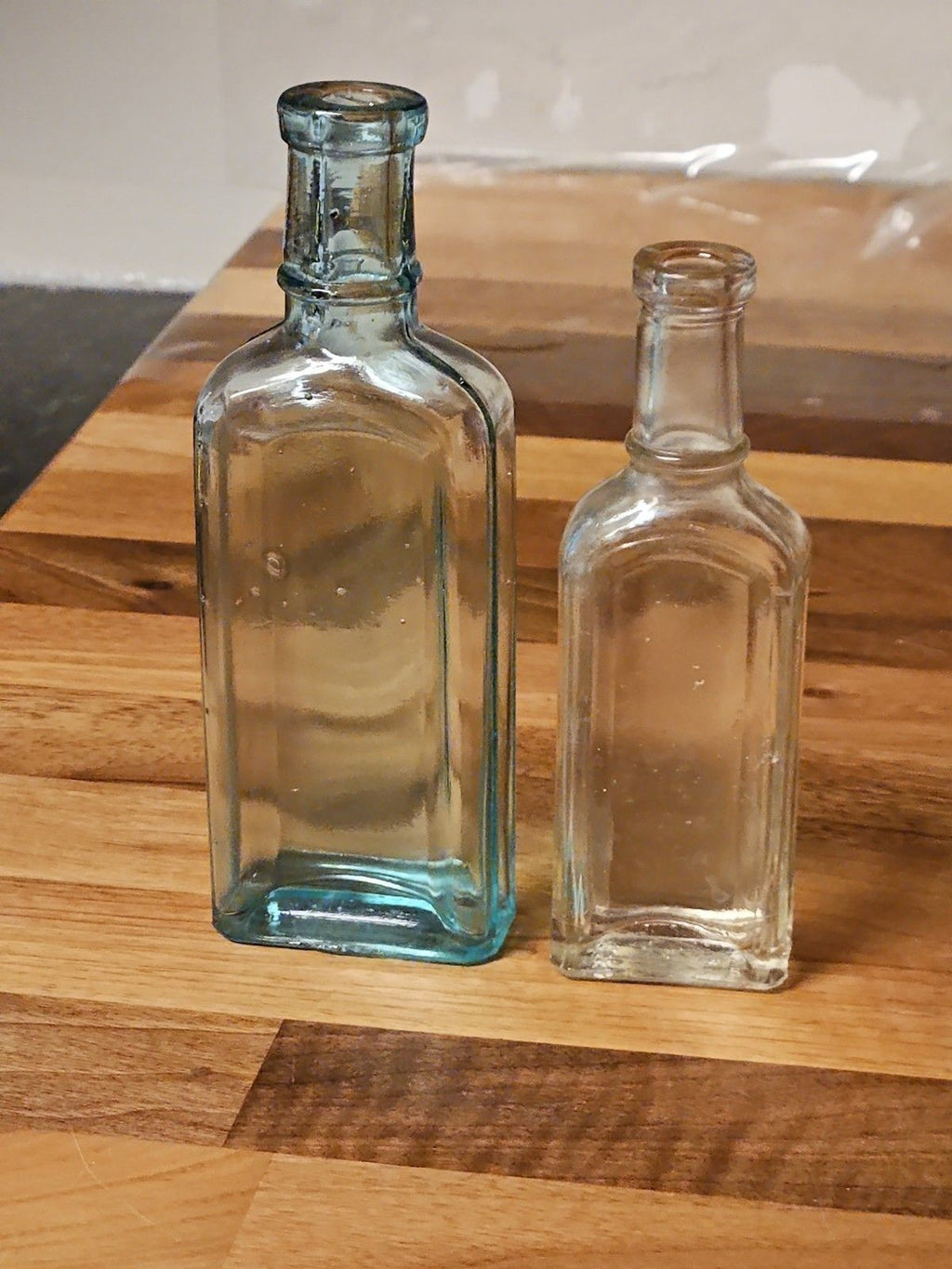 Set Of 2 Antique Medicine Bottles 5.5" & 4.75" Clear Aqua & Grey EUC